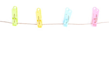Colorful clothes pins on rope isolated on white backgroundの写真素材