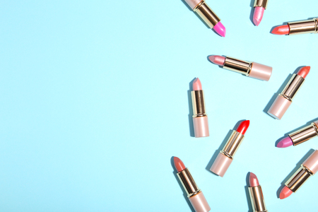 Many colorful lipstick on blue background. Cosmeticの写真素材