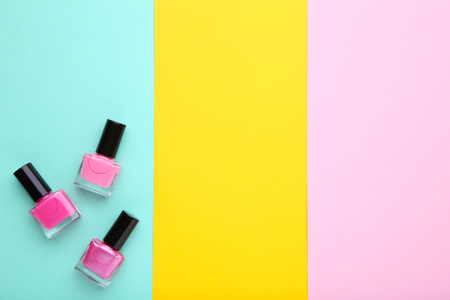 Group of pink nail polishes on colorful background, flat layの写真素材