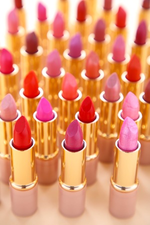 Many colorful lipstick on beige background. Cosmeticの写真素材