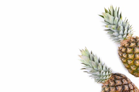 Two whole pineapples isolated on white background
