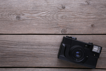 Vintage camera on grey wooden background. Old photo camera on grey wooden backgroundの写真素材