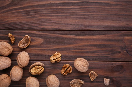 Walnuts kernels on brown background. Walnuts kernels on brown wooden tableの写真素材