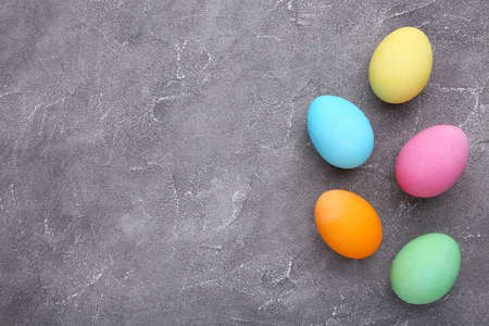 Colorful easter eggs on gray cement backgroundの写真素材