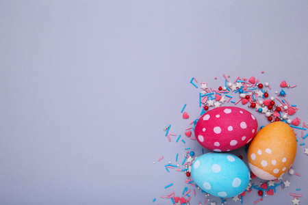 Three easter eggs on a gray background