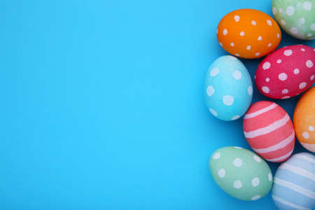 Colorful easter eggs on a blue background, flat layの写真素材
