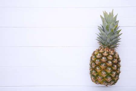 Fresh pineapple on a white wooden background