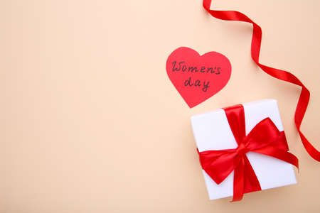 Womens Day concept with gift on a beige backgroundの写真素材
