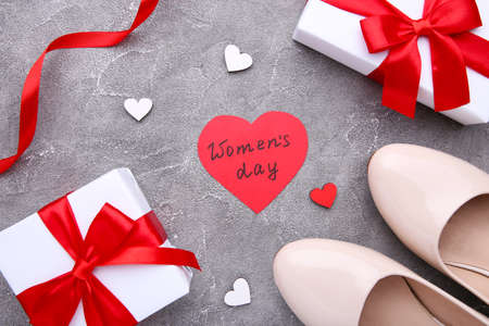 Womens Day concept with accessories on a gray background