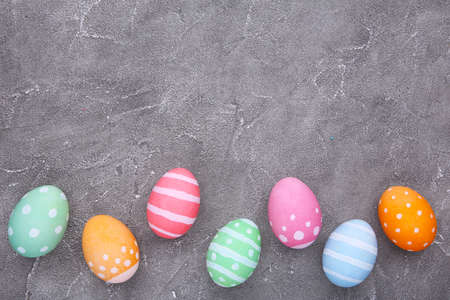 Colorful easter eggs on gray cement backgroundの写真素材