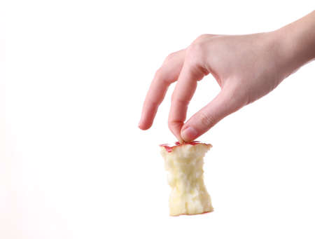 Hand holding apple stub isolated on a white backgroundの写真素材