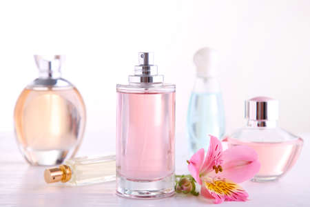 Many perfume bottles on a white background, top view