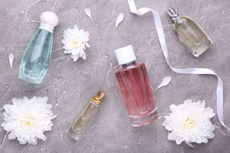 Many perfume bottles on a gray background, top viewの写真素材