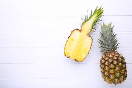 Fresh pineapples on a white wooden backgroundの写真素材