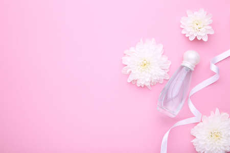 Many perfume bottle on a pink background, top viewの写真素材
