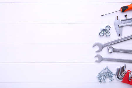 Different construction tools on wooden background with copy space.