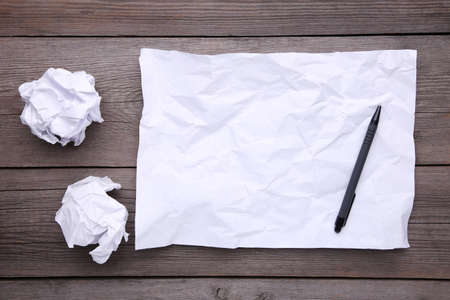 Stack white paper with pen on wooden tableの写真素材