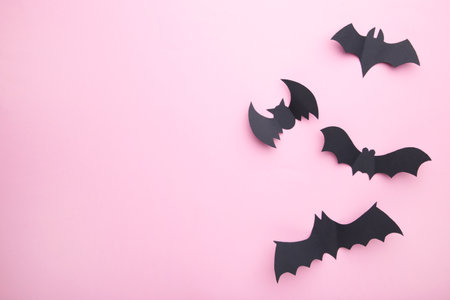 Halloween paper decorations on pastel pink background. Halloween concept. Flat lay, top view, copy spaceの写真素材