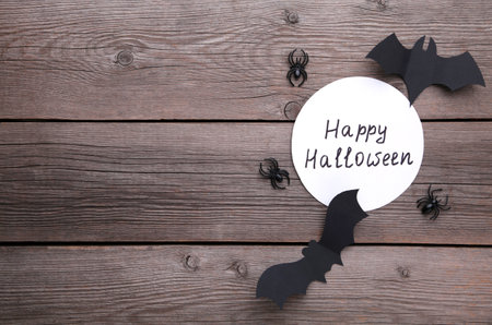 Halloween paper decorations on gray wooden background. Halloween concept. Flat lay, top view, copy spaceの写真素材