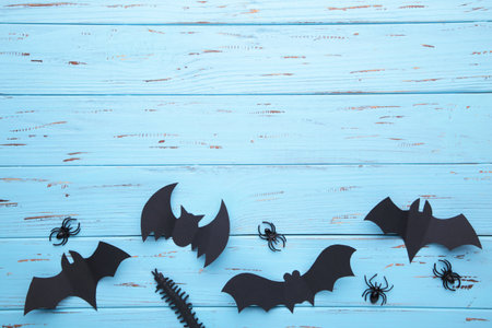 Halloween paper decorations on blue wooden background. Halloween concept. Flat lay, top view, copy spaceの写真素材