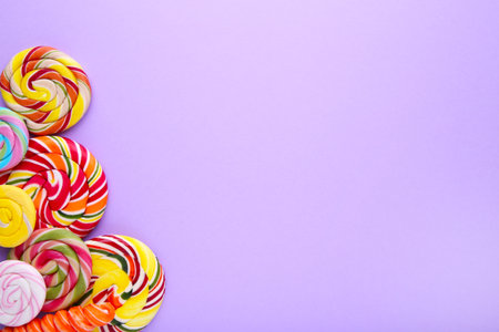 Lollipops on lilac background. Studio shot