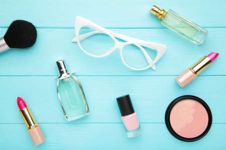 Makeup set on gray concrete background with copy space, top view. Cosmetics
