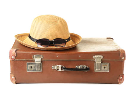 Leather old suitcase with hat isolated on white background. Top viewの写真素材