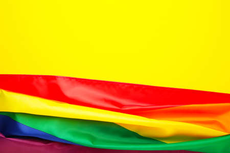 Rainbow LGBT flag on yellow background, top viewの写真素材
