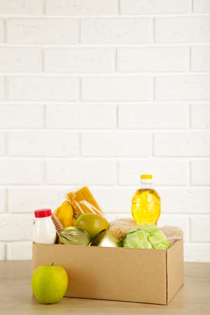Donation box with food on the white brick wall background.Top viewの写真素材