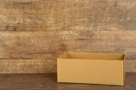 Cardboard box on white brick wall background. Top view