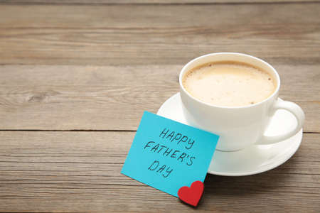 Fathers Day message with coffee cup on gray wooden background. Top viewの写真素材