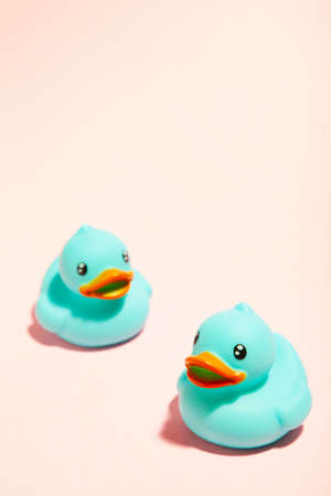 Blue rubber ducks organized on pink background. Top viewの写真素材