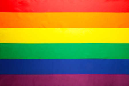 A rainbow flag background. LGBT, top view