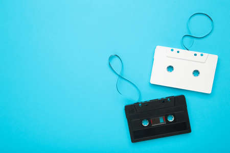Audio cassettes with magnetic tape on blue background with copy space. Top viewの写真素材