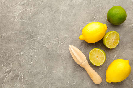 Fresh lime and lemon with citrus juicer stick. Top viewの写真素材