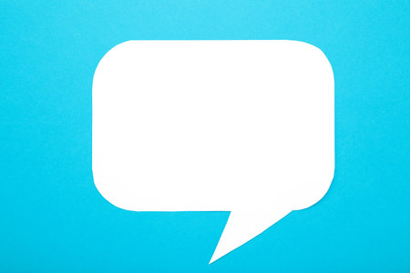 White paper speech bubbles on blue background. Top viewの写真素材