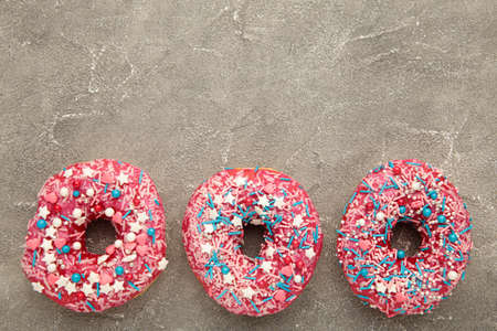 Baked sweet delicious donuts with pastry crumb on gray concrete background. Food textureの写真素材
