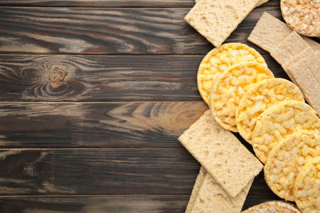 Various types of healthy whole grain crispbreads on brown wooden background. Top viewの写真素材