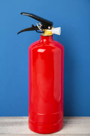 Fire extinguisher on the blue background.の写真素材