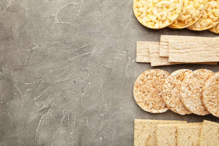 Various types of healthy whole grain crispbreads on gray background. Top viewの写真素材