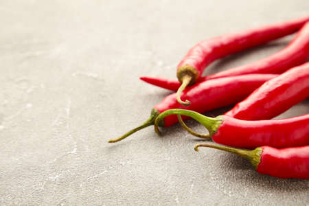 Red hot chili peppers on gray background. Top viewの写真素材