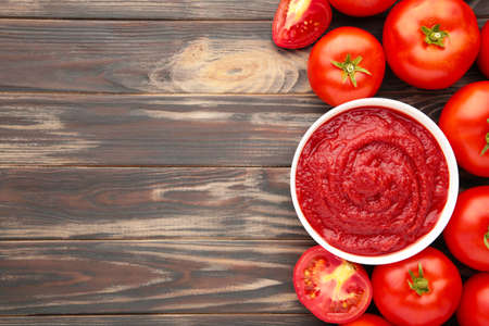 Tomato ketchup sauce in a bowl with tomatoes.の写真素材