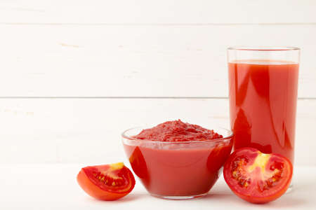Fresh tomatoes with paste and juice on white background. Top viewの写真素材