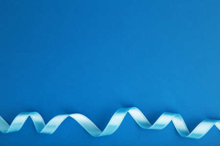 Blue ribbon on blue background with clipping path. Top viewの写真素材
