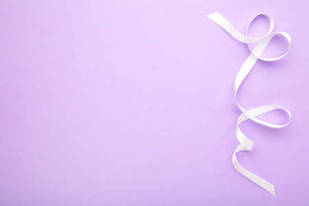 Purple ribbon on purple pastel background, design element. Top viewの写真素材