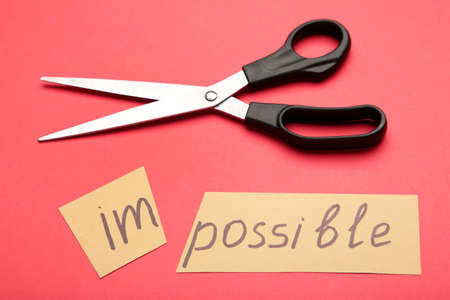 Impossible Is Possible Concept. card with the text impossible, cutting the word im so it written...