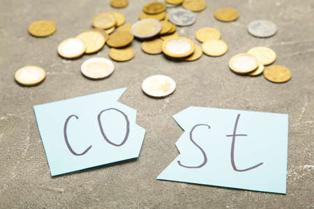 Scissors cutting the word costs concept for recession or credit crisis. Top viewの写真素材