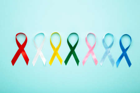 Collection of awareness ribbons on blue. World cancer day. Top viewの写真素材