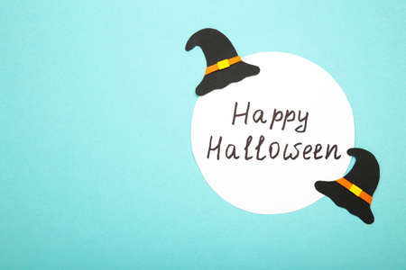 Happy halloween background with witch hat on blue. Top view