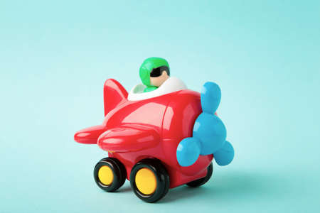 Plastic toy plane on blue background. Top viewの写真素材